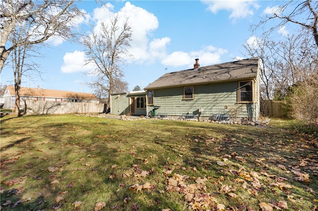 back of house with a yard