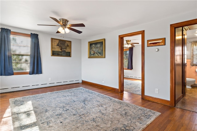 empty room with ceiling fan, dark hardwood / wood-style flooring, and baseboard heating