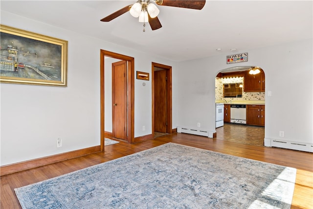 living room with dark hardwood / wood-style floors, a baseboard radiator, and ceiling fan