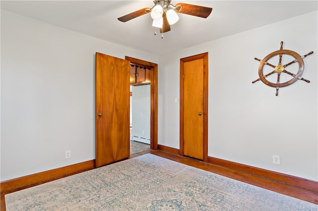 unfurnished bedroom featuring hardwood / wood-style floors, ceiling fan, and a baseboard radiator