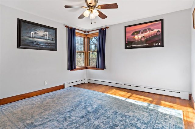 empty room featuring ceiling fan and hardwood / wood-style floors