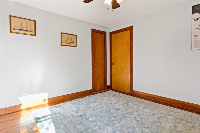 empty room featuring hardwood / wood-style floors and ceiling fan