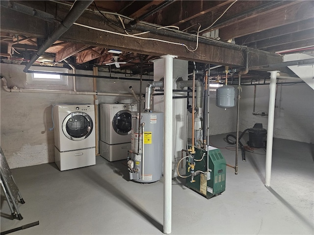 basement featuring water heater and independent washer and dryer