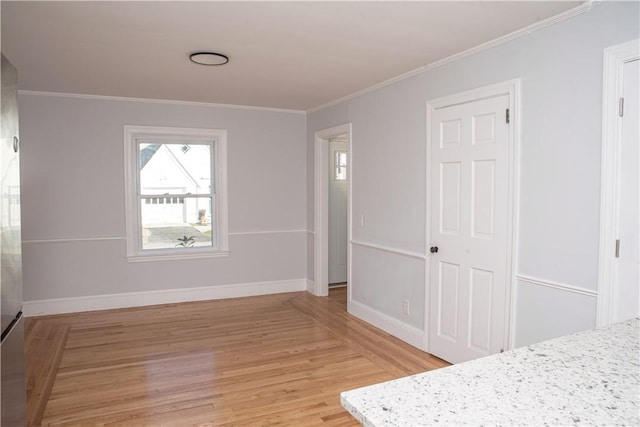 bedroom featuring crown molding and light hardwood / wood-style flooring