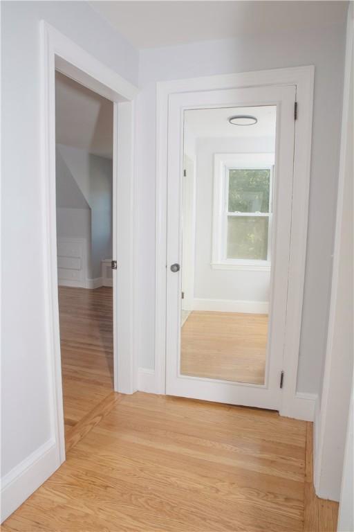 hallway with light hardwood / wood-style flooring