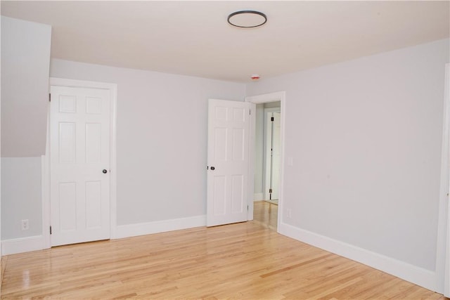 unfurnished room with light wood-type flooring