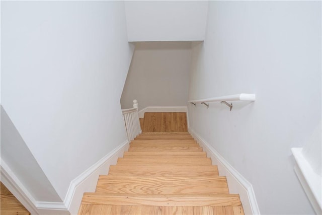 stairway with hardwood / wood-style flooring