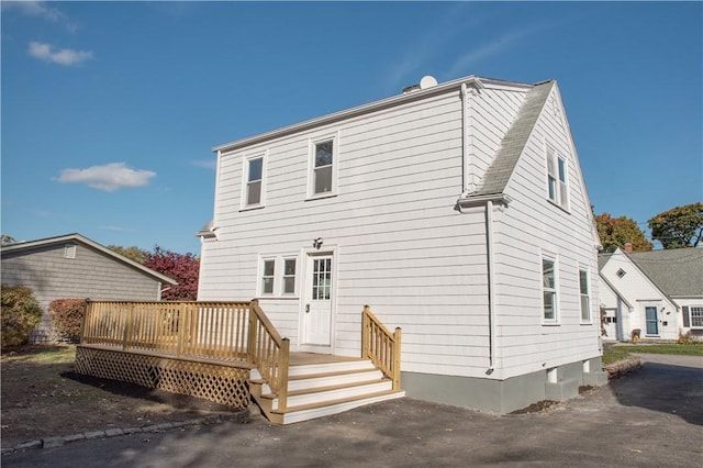 rear view of house featuring a deck