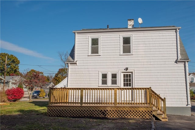 back of property featuring a wooden deck