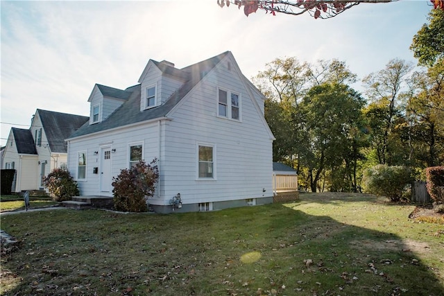 view of side of home with a yard