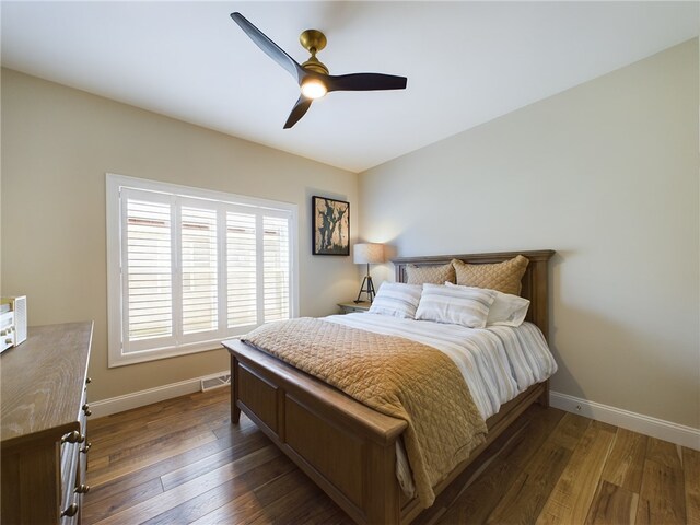 bedroom featuring ceiling fan and dark hardwood / wood-style flooring