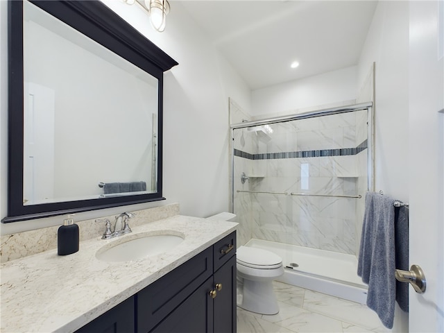 bathroom featuring vanity, an enclosed shower, and toilet