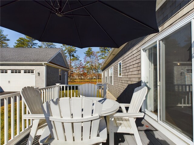 deck with an outbuilding and a garage