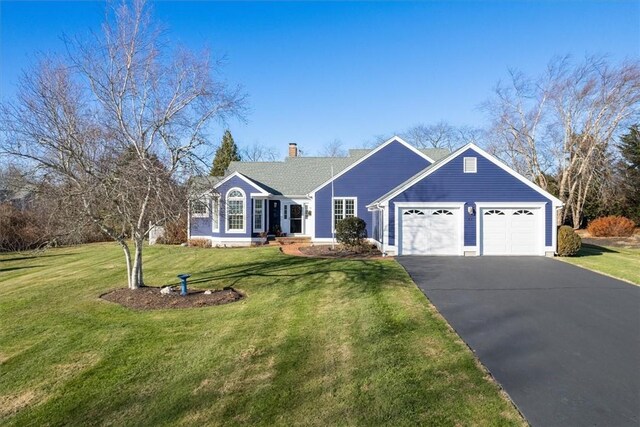 ranch-style house featuring a front lawn and a garage