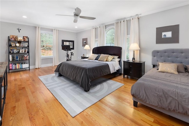 bedroom with ceiling fan, crown molding, and light wood-type flooring