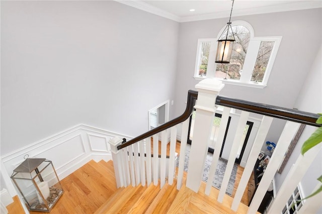 stairway featuring hardwood / wood-style flooring and ornamental molding