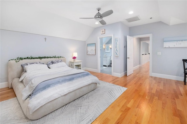 bedroom featuring connected bathroom, ceiling fan, light hardwood / wood-style floors, and lofted ceiling