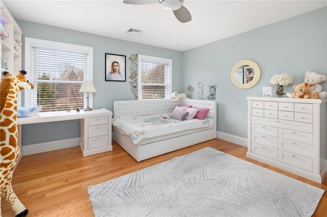 bedroom with ceiling fan and light hardwood / wood-style floors