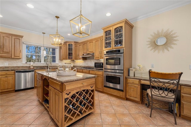 kitchen featuring light stone counters, backsplash, an island with sink, decorative light fixtures, and appliances with stainless steel finishes