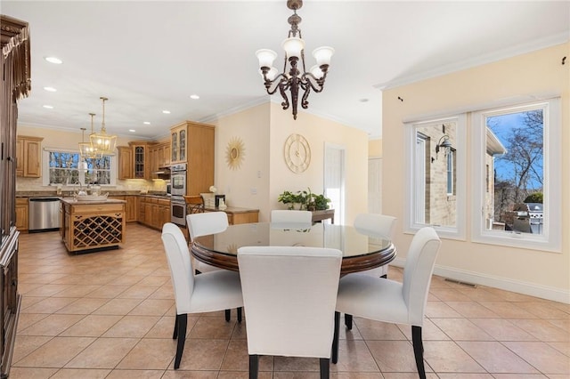 tiled dining space with a wealth of natural light, a chandelier, and ornamental molding