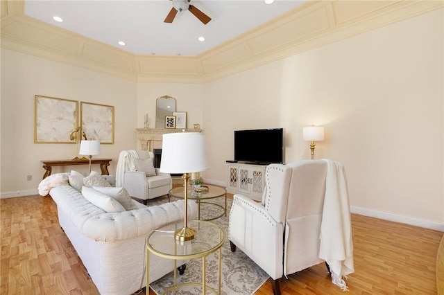 living room with ceiling fan, light hardwood / wood-style floors, and ornamental molding