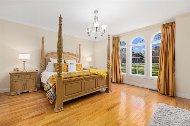 bedroom with a chandelier, light hardwood / wood-style floors, and ornamental molding