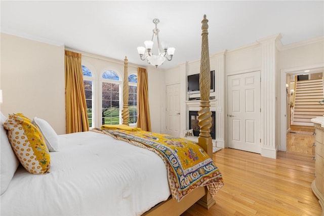 bedroom with a chandelier, light hardwood / wood-style floors, and ornamental molding