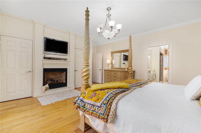 bedroom featuring an inviting chandelier, wood-type flooring, and ornamental molding