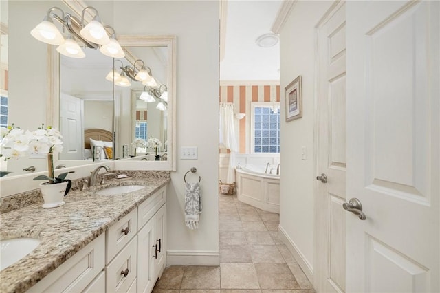 bathroom with tile patterned floors, vanity, crown molding, a chandelier, and a tub