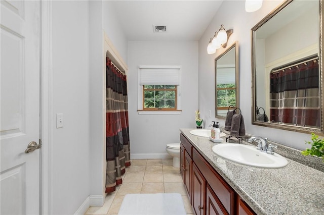 bathroom featuring tile patterned floors, vanity, and toilet