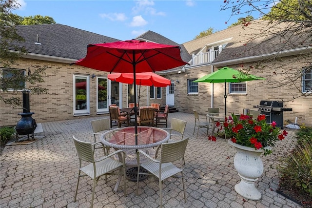 view of patio / terrace with area for grilling and a fire pit