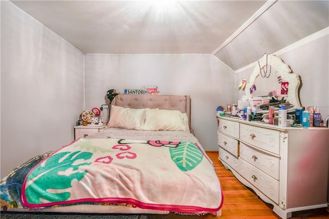 bedroom featuring light hardwood / wood-style flooring and vaulted ceiling