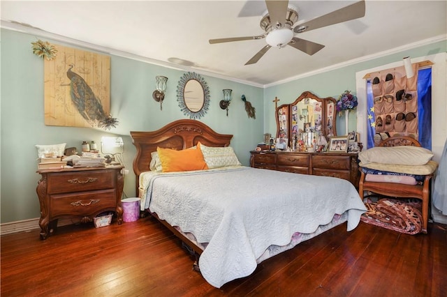 bedroom with dark hardwood / wood-style floors, ceiling fan, and ornamental molding