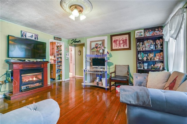 living room with hardwood / wood-style floors and a textured ceiling