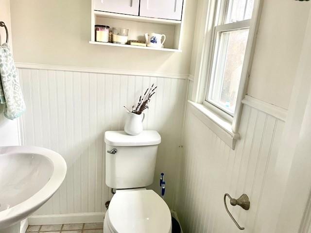 bathroom featuring sink, tile patterned flooring, and toilet