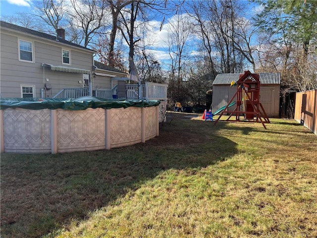 view of yard with a covered pool and a storage shed