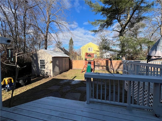 deck with a playground and a shed