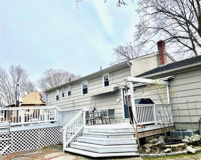 rear view of house featuring central air condition unit and a deck