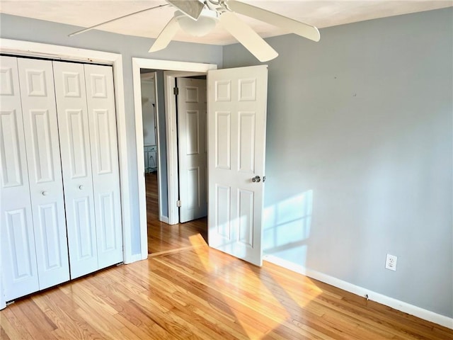 unfurnished bedroom with light wood-type flooring, a closet, and ceiling fan