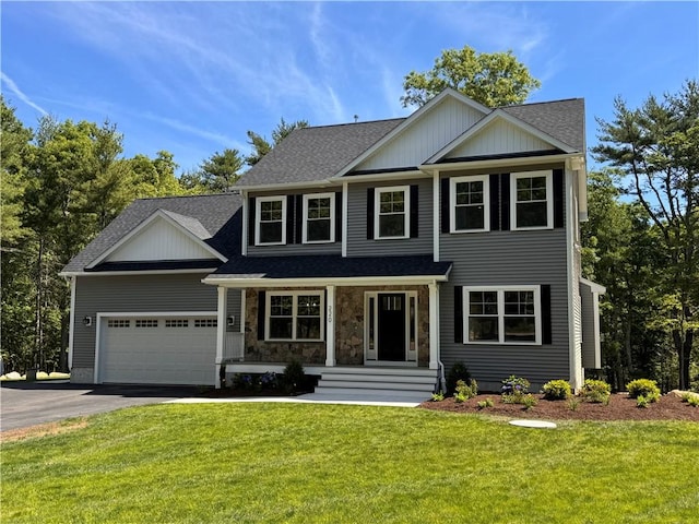 view of front of house featuring a front yard and a garage