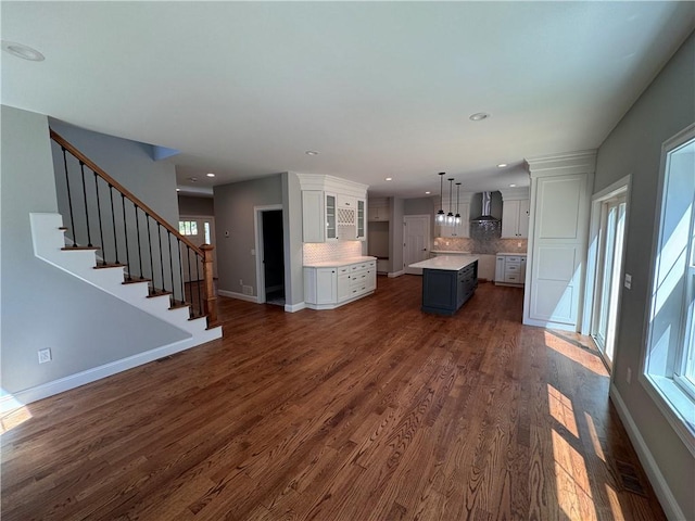 unfurnished living room with dark hardwood / wood-style floors