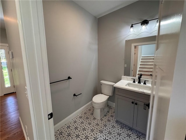 bathroom featuring vanity, hardwood / wood-style flooring, and toilet