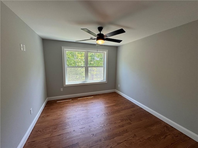 unfurnished room featuring ceiling fan and dark hardwood / wood-style flooring