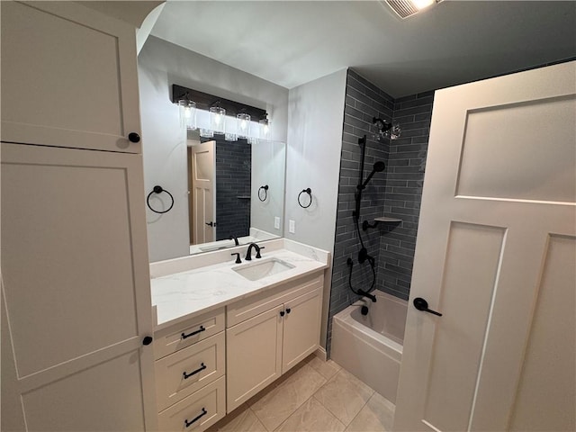 bathroom featuring vanity and tiled shower / bath combo