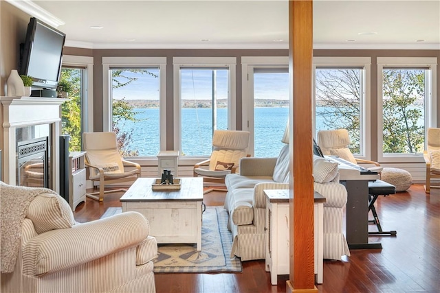 sunroom / solarium featuring a water view and plenty of natural light