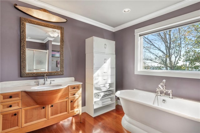 bathroom featuring hardwood / wood-style floors, vanity, shower with separate bathtub, and ornamental molding