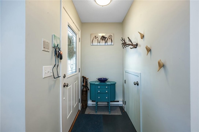 doorway to outside featuring a textured ceiling