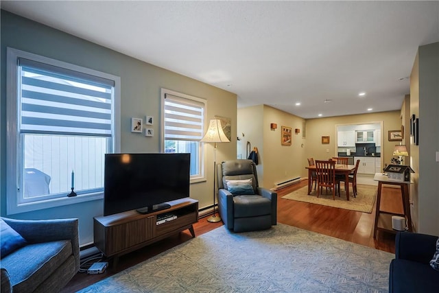 living room with a baseboard radiator and light hardwood / wood-style flooring