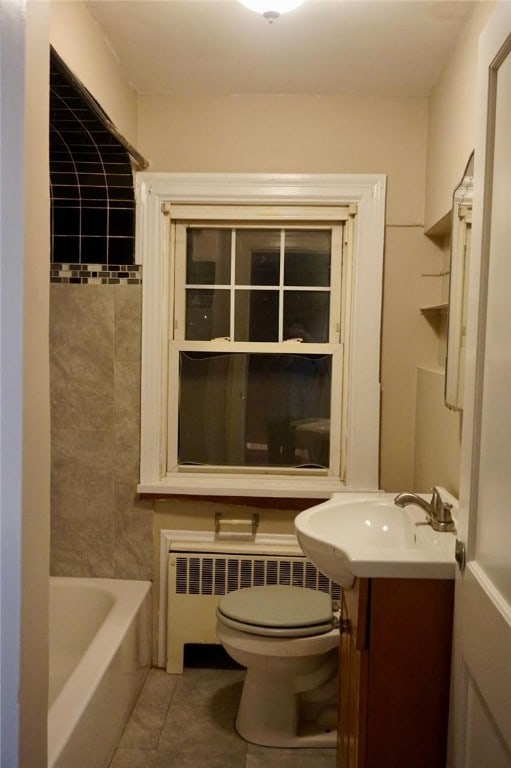 bathroom featuring tile patterned floors, radiator heating unit, vanity, and toilet