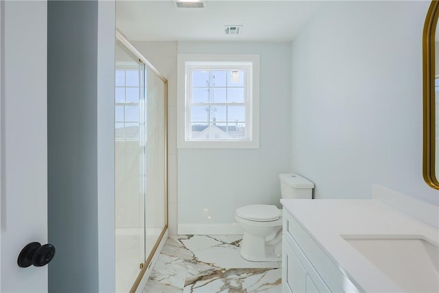 bathroom with vanity, toilet, and a shower with door